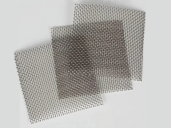 Three square stainless steel woven meshes stacked together